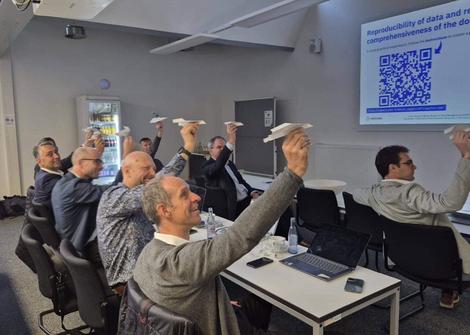 Participants at the MHI meet 2026 showing their paper airplanes.